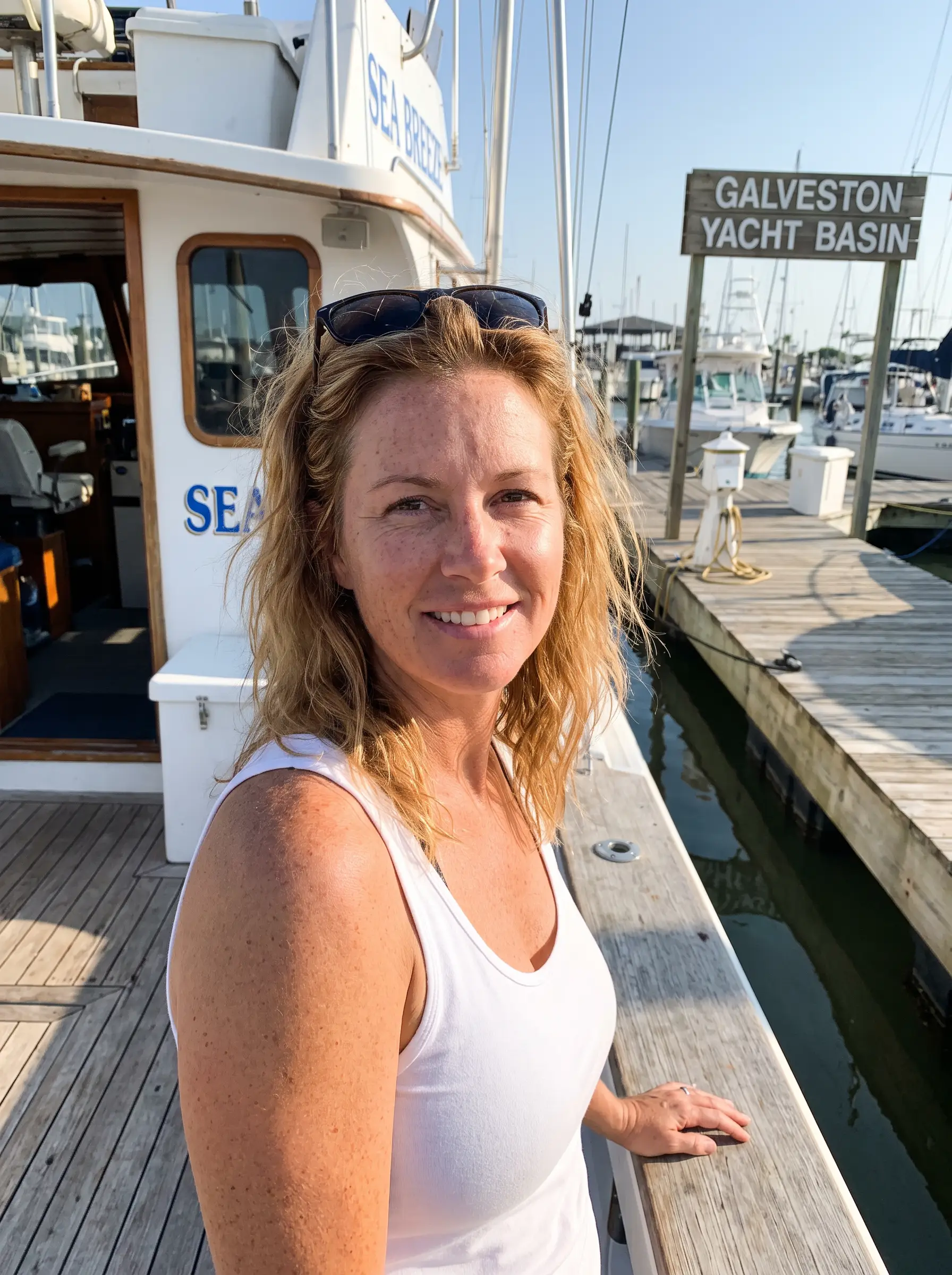 Amanda on the deck of her charter boat at a Galveston marina
